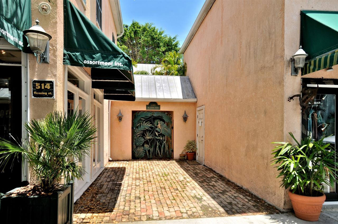 Street view of 512 Fleming showing the terracotta entrance with gecko gate between Old Town storefronts